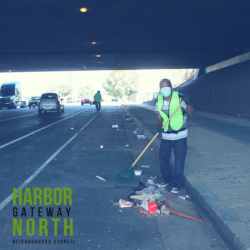 person sweeping under a freeway